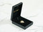 Golden Elegance 18k Gold H Doll Pendant in black jewelry box showcasing art gold jewelry