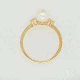 Golden Elegance: Stunning 7mm pearl ring with diamond accents