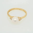 Golden Elegance: Stunning 7mm pearl ring with diamond accents