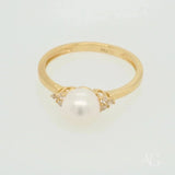 Golden Elegance: Stunning 7mm pearl ring with diamond accents