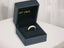 Open dark gray jewelry box with Golden Grace 18k Aparador Ring exuding timeless elegance