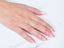 Woman’s hand with golden grace 18k aparador ring and French-tip manicure with gold accents