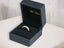 Open dark blue ring box showcasing Golden Grace 18k Aparador Ring with gold diamond band