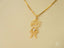 Gold boy-shaped pendant with diamond-studded heart on delicate chain, part of art gold jewelry collection