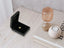 Small golden heart pendant in open black jewelry box, crafted from 18k solid gold