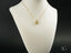 Art gold jewelry golden heart pendant on display bust in 18k solid gold
