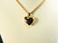 Lustrous 18k solid gold heart-shaped pendant on delicate chain, epitome of timeless elegance