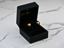 Open 18k gold heart stud earrings in black jewelry box