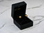 Open black jewelry box showcasing elegant 18k gold heart-shaped stud earrings from Art Gold Jewelry