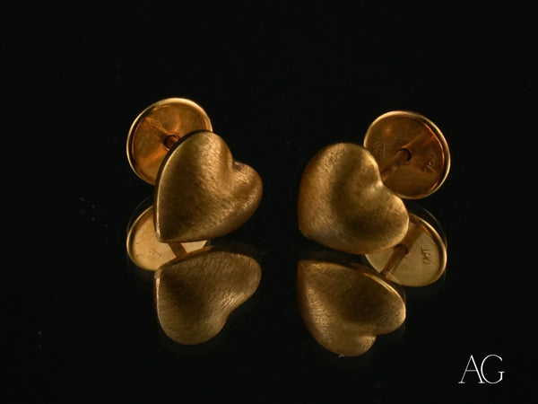 Pair of textured 18k gold heart-shaped stud earrings in art gold jewelry