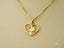 Golden Love Pendant featuring an 18k Gold Heart with clear gemstones symbolizing eternal love