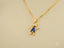 Elegant golden love pendant featuring a boy-shaped design with blue gemstones in 18k solid gold