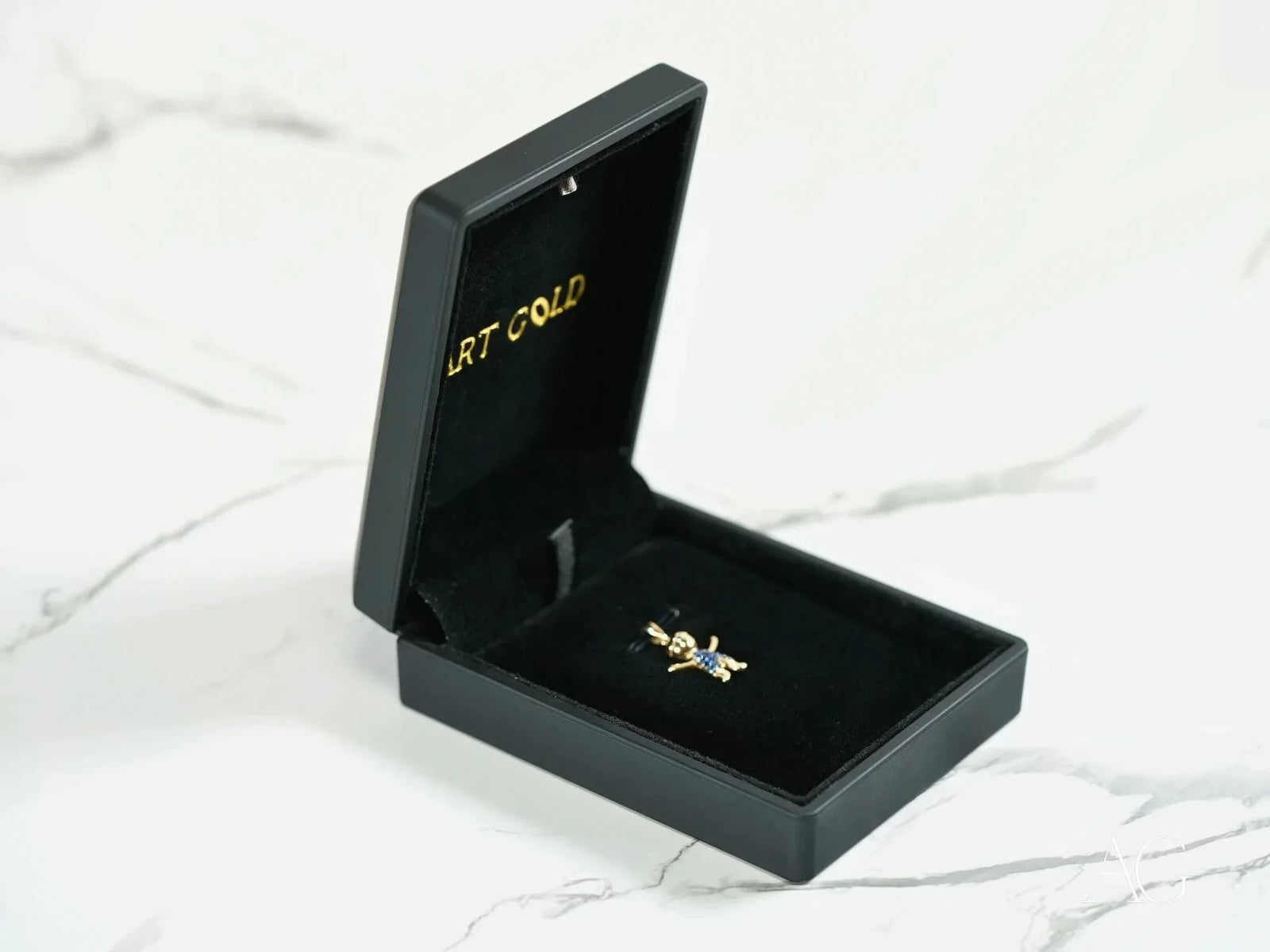 Open black jewelry box with 18k solid gold love pendant charm