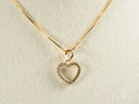 18k solid gold heart-shaped pendant with sparkling white stones