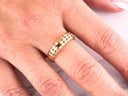 Golden Mesh Elegance ring with intricate openwork design and green gem