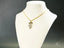 Golden Moments art gold jewelry featuring a girl dancing pendant with white stones
