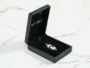 Open black jewelry box with Golden Moments 18k gold CZ girl dancing pendant