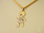 Golden Moments art gold jewelry girl dancing pendant featuring a gold boy figure with cubic zirconia