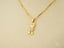 Art gold jewelry Golden Play pendant featuring an 18k solid gold boy-shaped design with clear stones