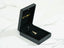 Open black jewelry box with 18k solid gold Golden Ride Pendant charm, art gold jewelry