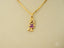 Golden Ruby Doll 18k gold necklace with girl-shaped pendant wearing purple dress
