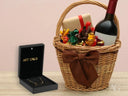 Golden Signature Necklace in open box with gift basket of wine and chocolates
