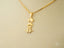 Golden Skater Pendant featuring a boy on a skateboard in 18k solid gold art gold jewelry