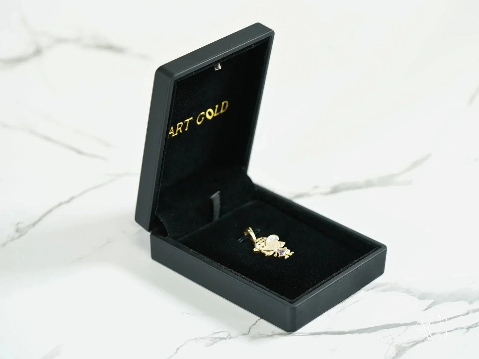 Open black jewelry box with 18k solid gold Golden Son Pendant
