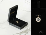Golden Spark Pendant: 18k solid gold evil eye charm with blue and white stones in black box