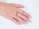 Hand with French-tipped nails wearing Golden Spectrum 18k 3-tone ring