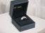Gold ring with diamonds showcasing the Golden Spectrum 18k 3-tone tri-tone design in a jewelry box