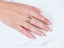 Hand wearing a wide braided 18k 3-tone ring from Golden Spectrum showcasing elegance meets versatility
