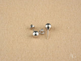 Three 18k white gold 5mm ball earrings with screw-back and post-back closures