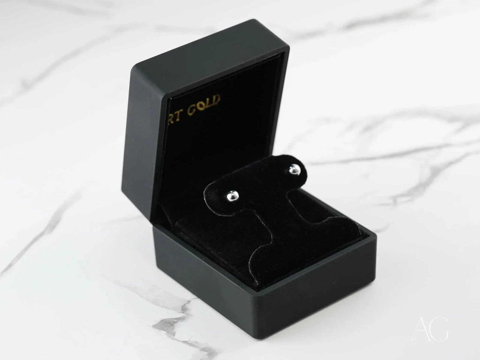 Opened 18K white gold 5mm ball earrings in black velvet box