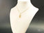 Elegant gold chain necklace with abstract shoes pendant from Golden Steps Jewelry