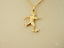 Golden Striker pendant featuring a soccer player design on a chain, crafted in art gold jewelry style
