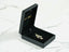 Open black jewelry box with Golden Treasures Pendant featuring 18k solid gold girl-shaped art gold jewelry