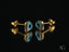 Four gold stud earrings with blue evil eye designs, featuring heart evil eye motifs