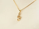 Gold treble clef necklace in Harmonic Elegance Pendant with cubic zirconia accents