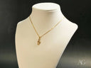 Harmonic Elegance Pendant: Gold Necklace with Treble Clef