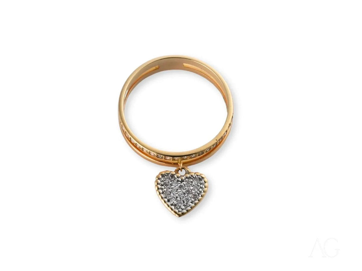 Radiant 18k gold Heart’s Glow Ring with dangling heart charm