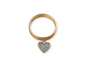 Radiant 18k gold Heart’s Glow Ring with dangling heart charm