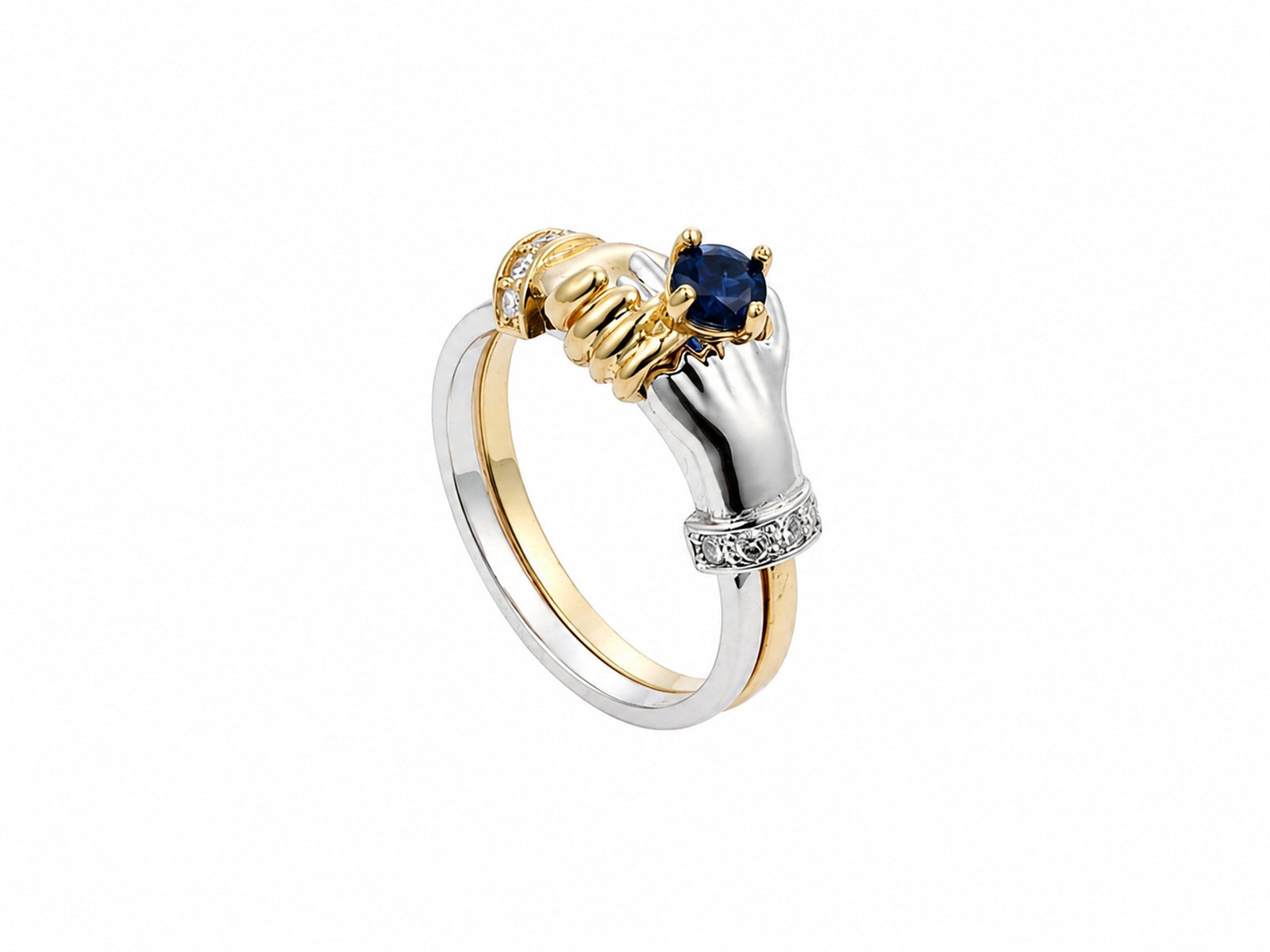 Three-quarter view of two-tone gold ring with sculpted clasped hands holding sapphire, diamond cuff accents