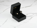 Lucky Cat 18k gold earrings in open black velvet-lined jewelry box