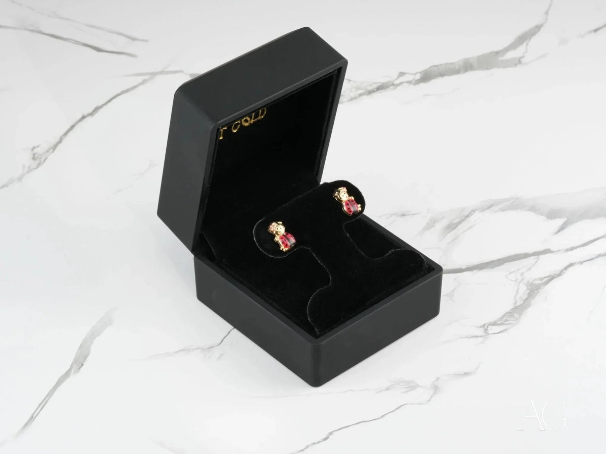 Black jewelry box with 18k gold ladybug stud earrings for kids