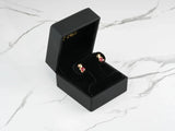 Black jewelry box with 18k gold ladybug stud earrings for kids