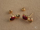 Pair of 18k gold ladybug stud earrings with red and black enamel