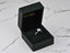 Open black ring box showcasing Lumina Promise Solitaire with classic four‑prong art gold setting