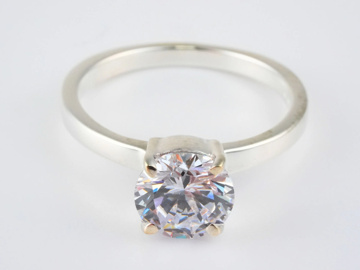 Lumina Promise Solitaire: classic four-prong silver ring with round-cut clear diamond