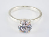 Lumina Promise Solitaire: classic four-prong silver ring with round-cut clear diamond